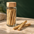 Split U.S.-grown piñon pine batons in a tall six-sided glass vessel