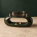 Low oval green ceramic tea-light warmer with smoked-glass cup and brass supports